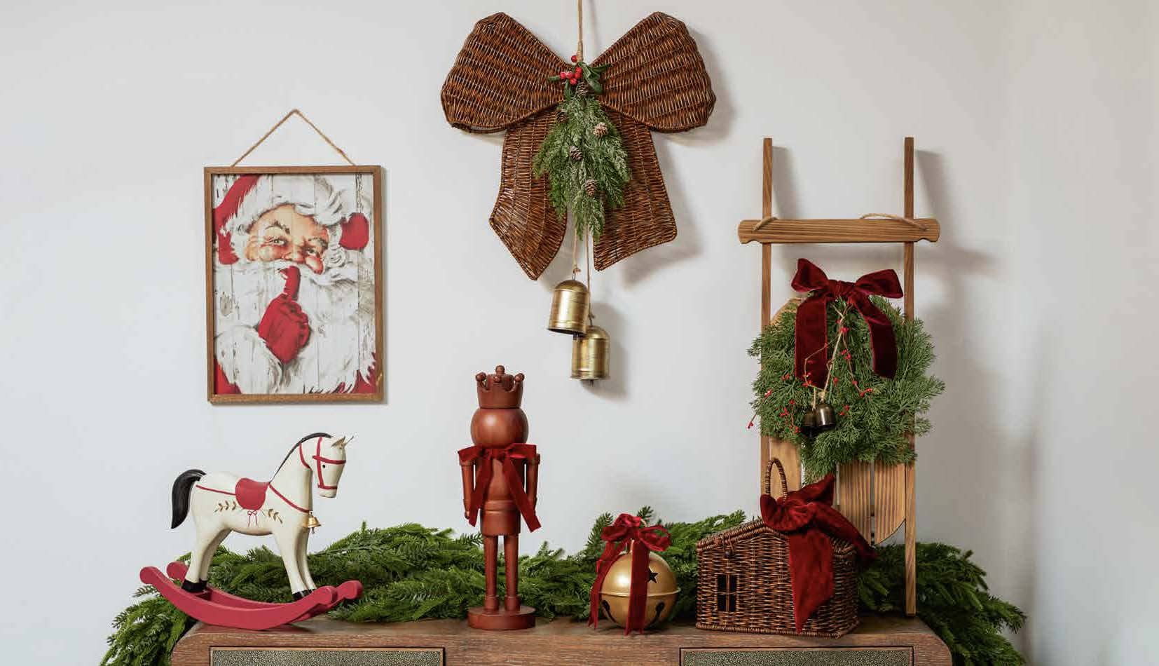 A festive bow and greenery above a Christmas display