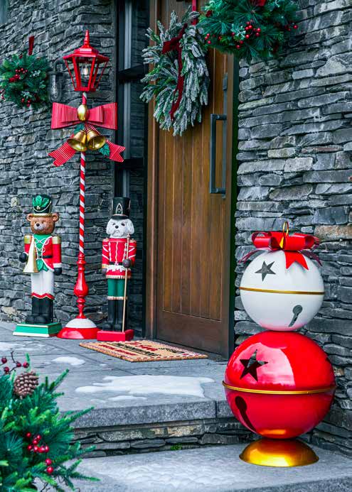 Christmas wreaths, nutcrackers and festive bells beside a front door