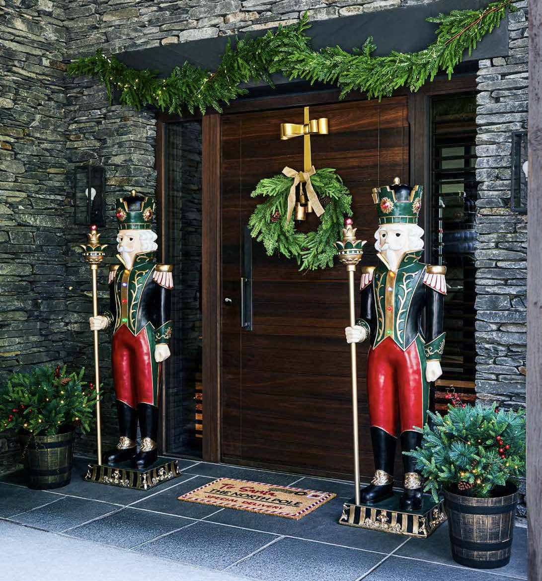 Christmas nutcrackers beside a decorated doorway