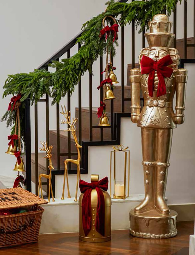Gold nutcracker, bells and festive ribbon